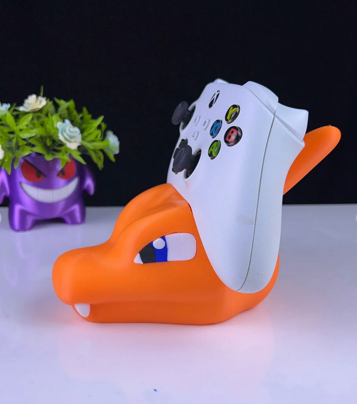 3DPrintingLabDesigns Charizard controller stand holding a white Xbox controller next to a Gengar planter