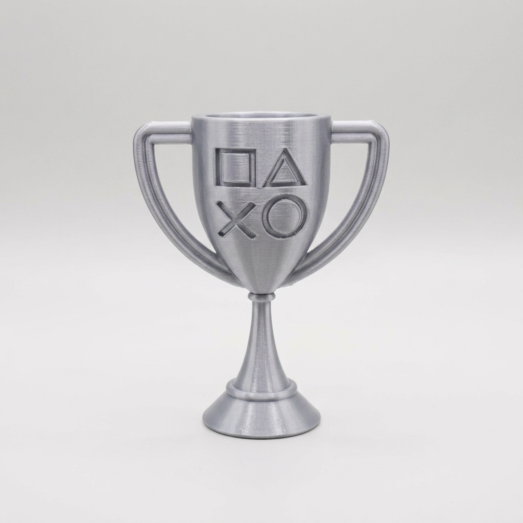 Silver 3D-printed PlayStation-style cup trophy with controller symbols on a light gray background