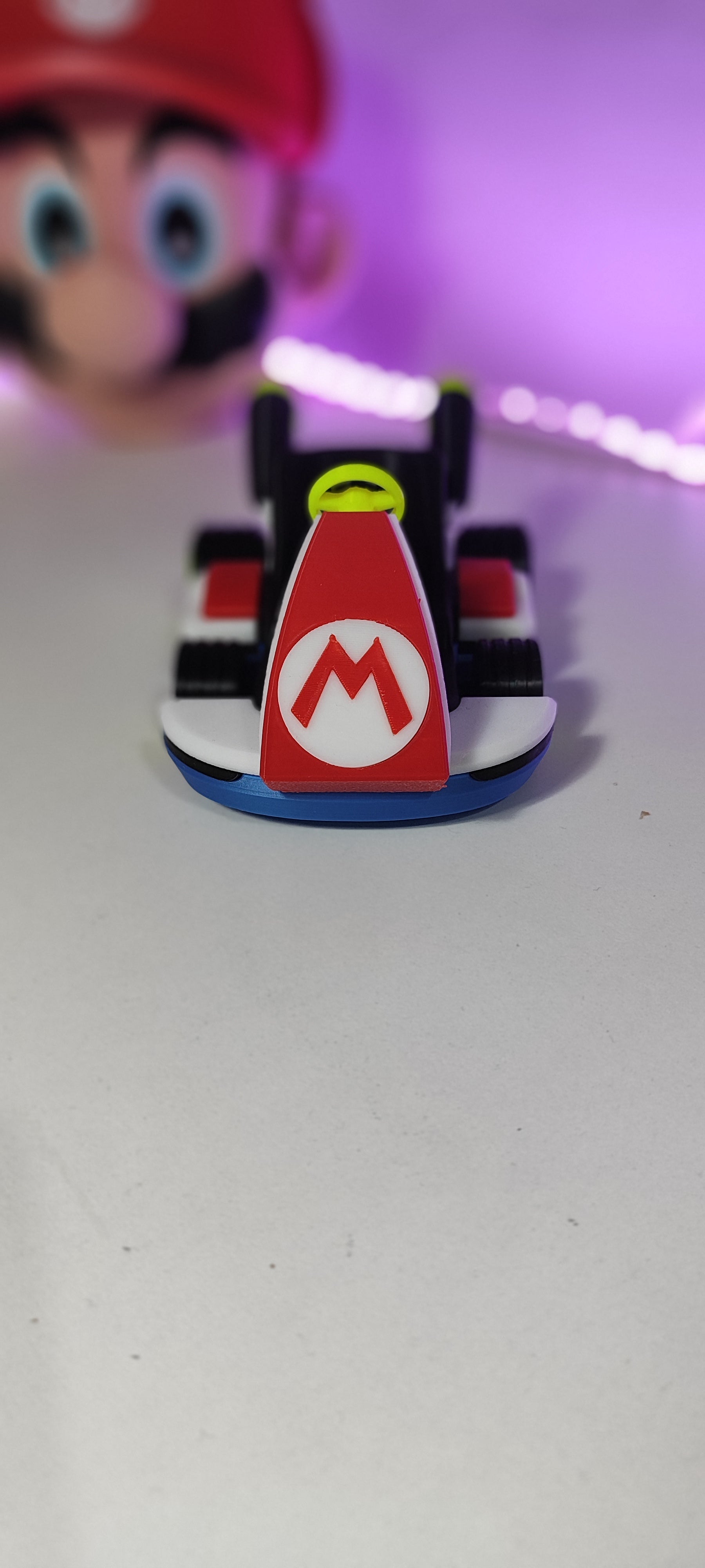 Front view of the Mario Kart 8 miniature replica, showcasing the bold 'M' logo and sleek design