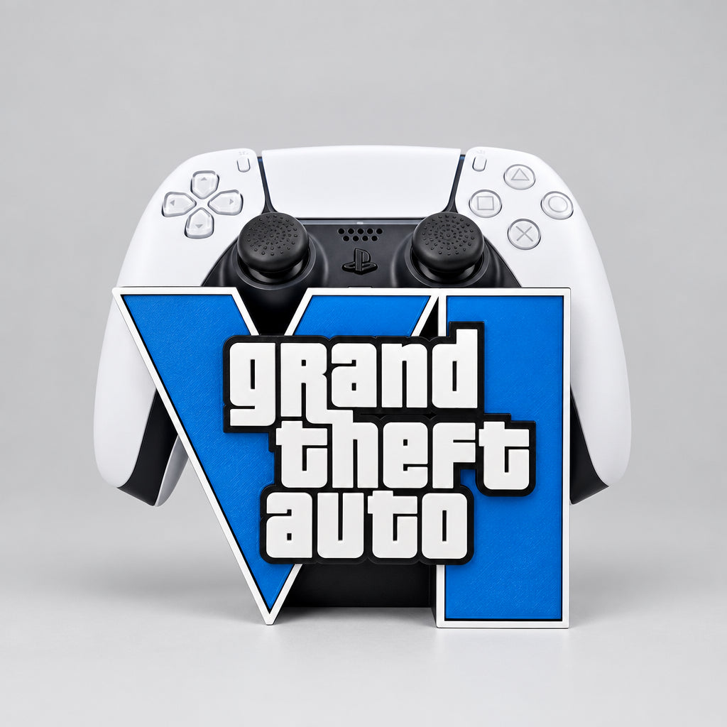 A multicolor universal controller stand with 'GRAND THEFT AUTO' text on the front, displayed with other gaming-related items in the background.