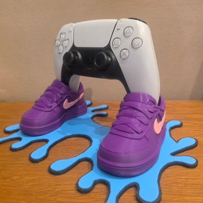3DPrintingLabDesigns sneaker-inspired PS5 controller stand with purple shoes on a blue drip base holding a controller