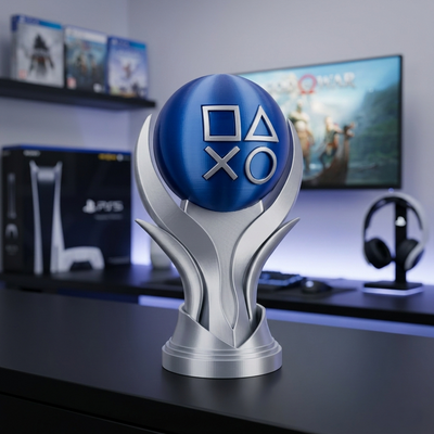 PlayStation trophy with logo on a desk in front of a gaming setup