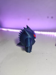 Gengar 3D Pokémon figure showcased on a gaming desk in a man cave setting.