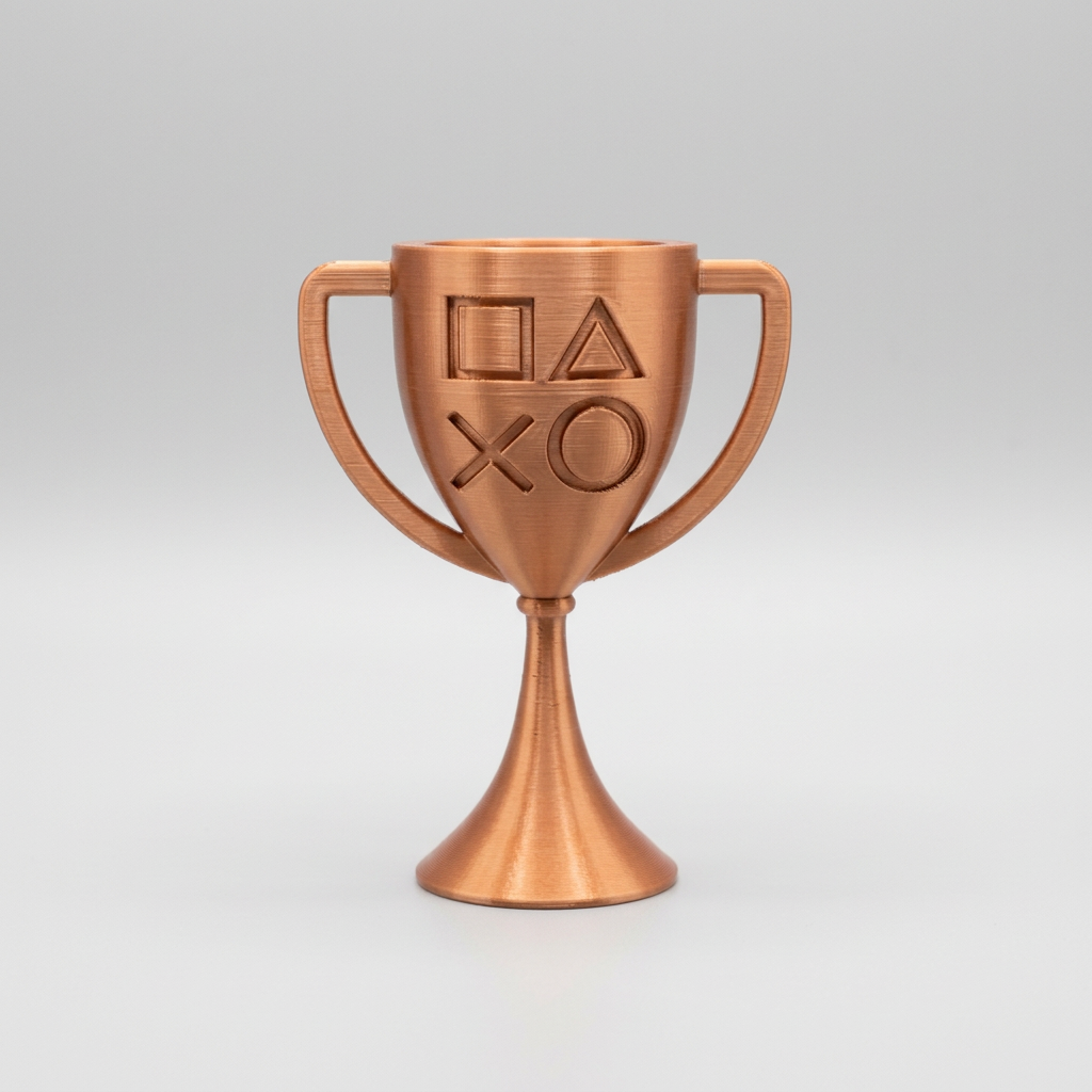 Bronze 3D-printed PlayStation-style cup trophy with controller symbols on a light gray background