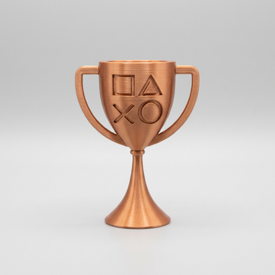 Bronze 3D-printed PlayStation-style cup trophy with controller symbols on a light gray background