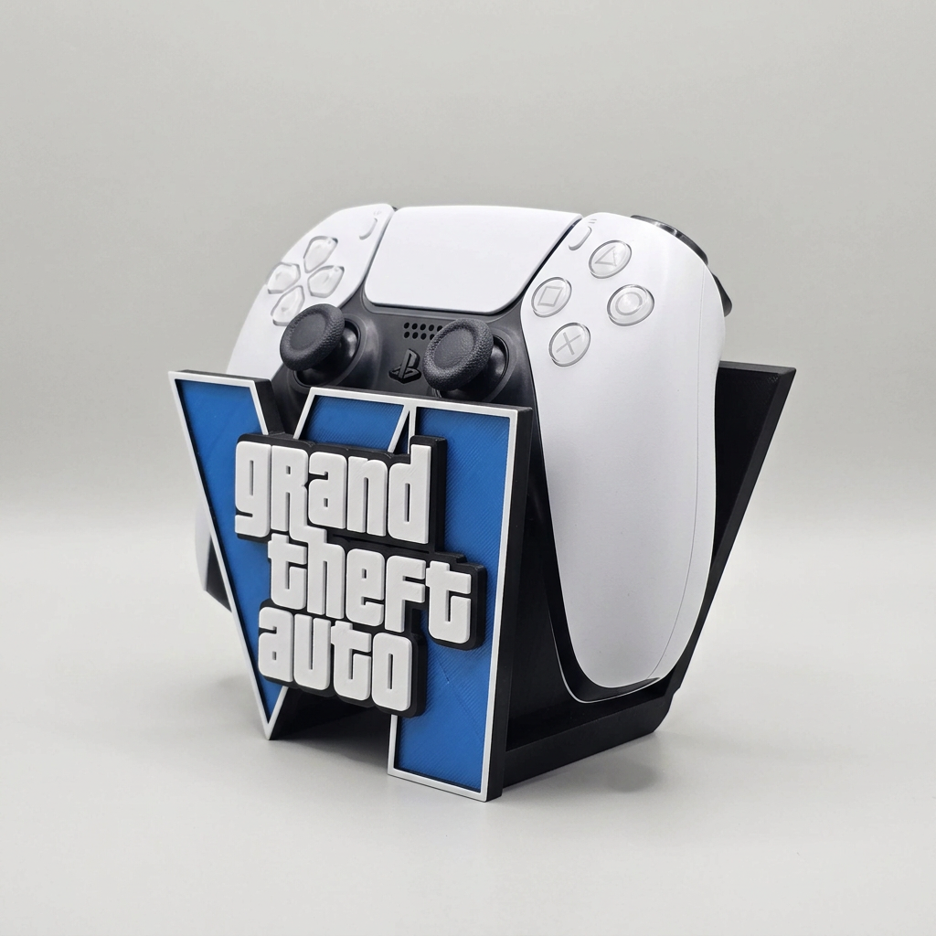 A white and black PlayStation 5 dualsense displayed on a black stand featuring a blue and white Grand Theft Auto logo, set against a neutral gray background.