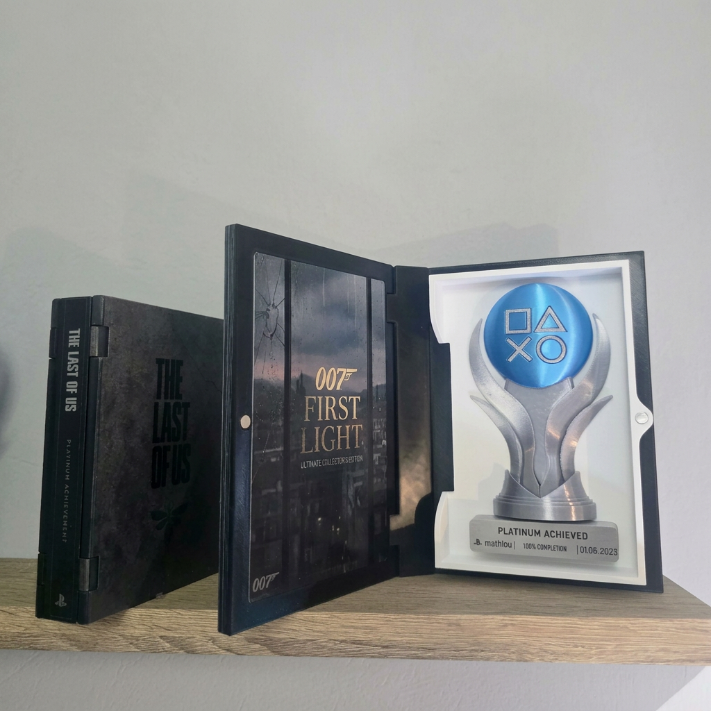 Open 007 First Light 3D printed display case with a personalized blue and silver platinum trophy on a wooden shelf