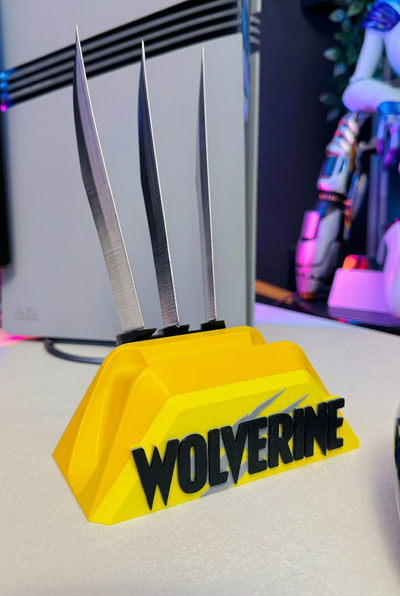 Wolverine controller stand without a controller, showing the yellow base, black lettering and three decorative claws.