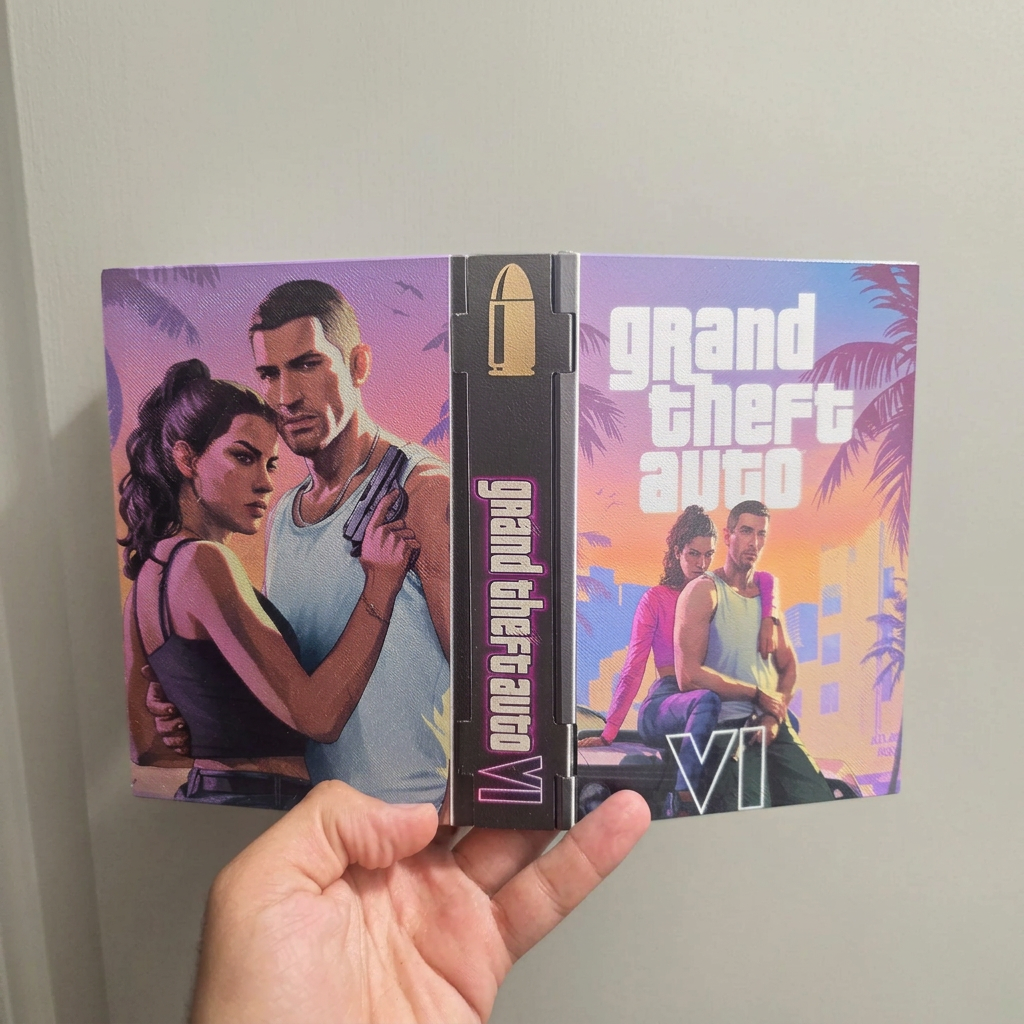 Hand holding an open custom GTA VI 3D printed display case showing the front cover, spine and back artwork