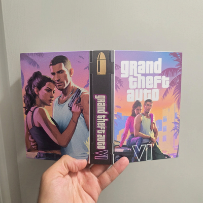 Hand holding an open custom GTA VI 3D printed display case showing the front cover, spine and back artwork