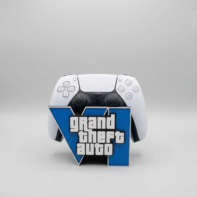 A white PlayStation 5 controller with a custom skin featuring the Grand Theft Auto V logo, displayed on a light gray background.