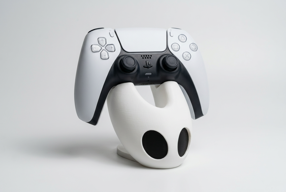 Hollow Knight Silksong Hornet controller holder with white DualSense, studio visualization
